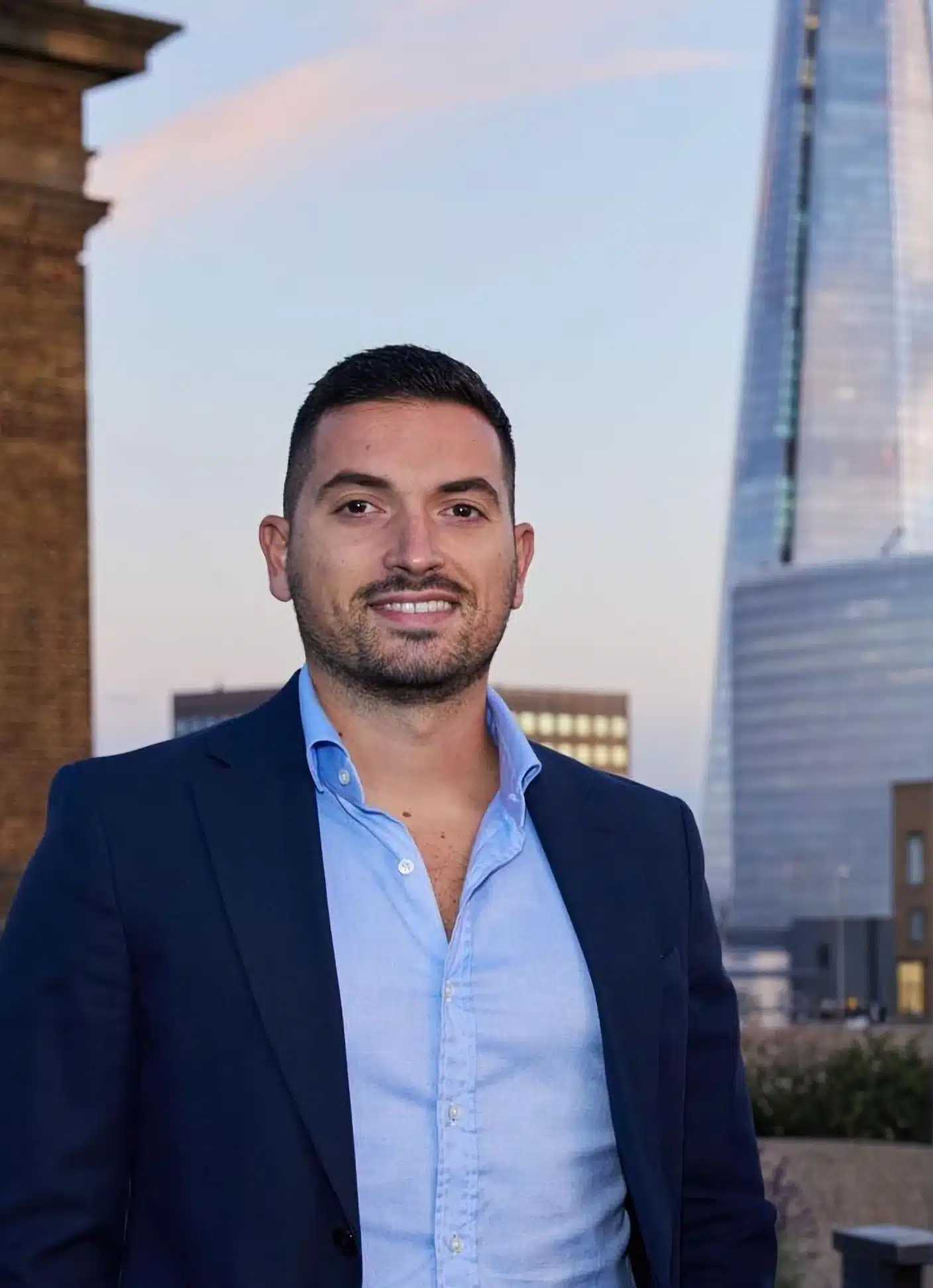 Massimiliano Tagliapietra, Professional property manager in London, specializing in residential and short lets with iconic skyline in the background. MX Lettings Property Managers London