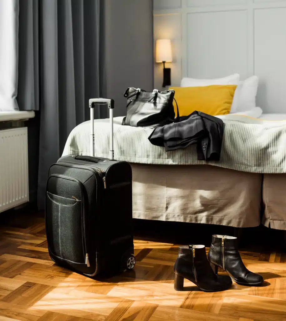 Stylish bedroom setup for short lets in London, featuring luggage, shoes, and modern decor for residential stays. MX Lettings Property Managers London