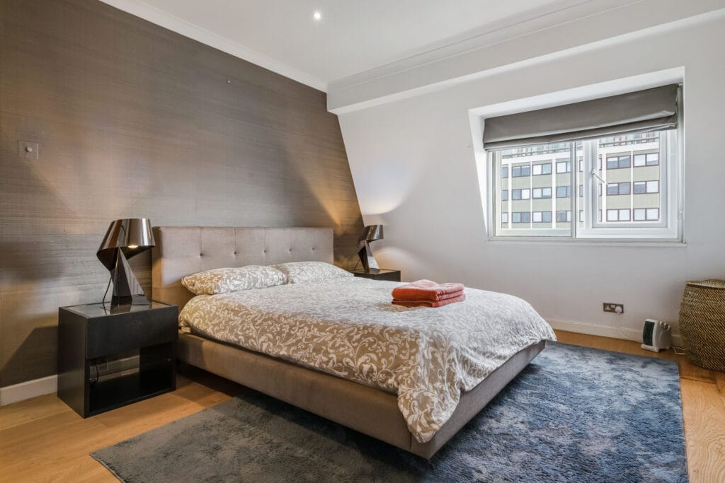 Stylish bedroom in a London property managed for residential lettings and holiday lets, featuring modern decor and ample natural light. MX Lettings Property Managers London