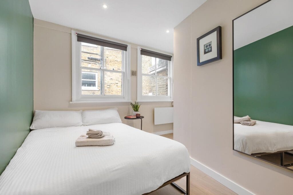 Cozy bedroom in a London property, ideal for residential lettings and holiday lets agency services. MX Lettings Property Managers London
